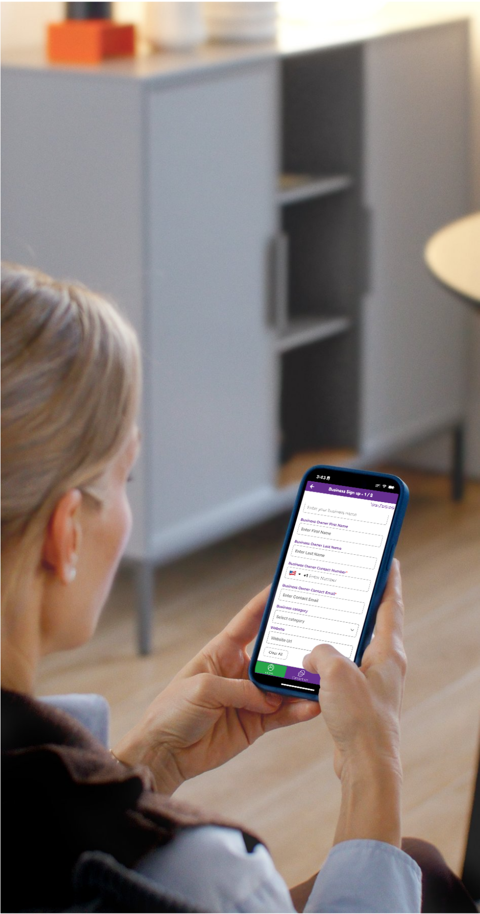 Salon owner or spa manager using the DealMagik app for mobile appointment scheduling and client management.