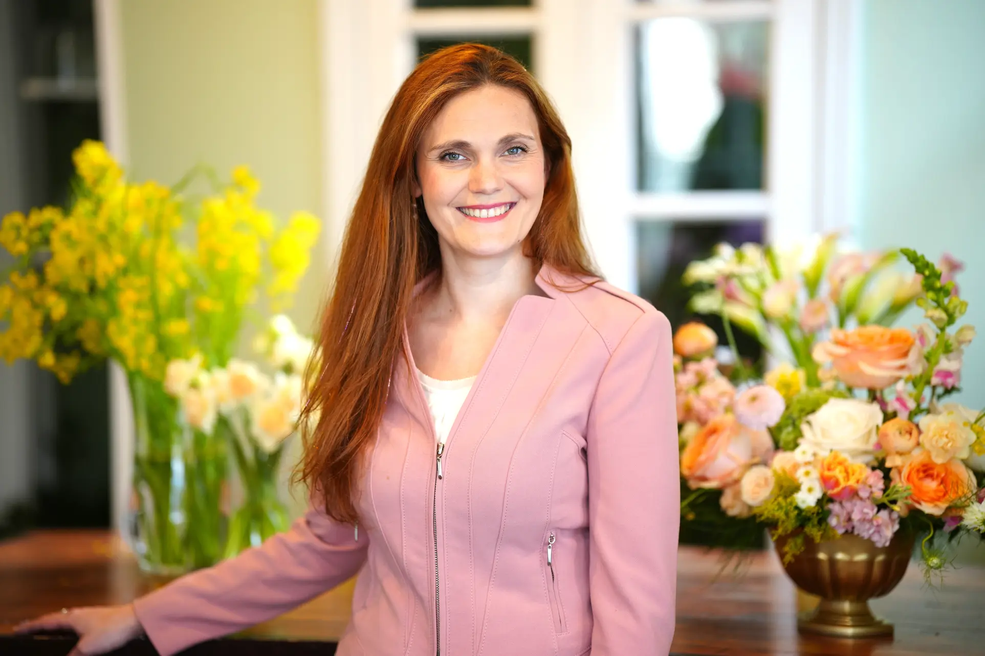 Rosaspina Floral Designs owner Lindsey Vandevier with colorful flower arrangements